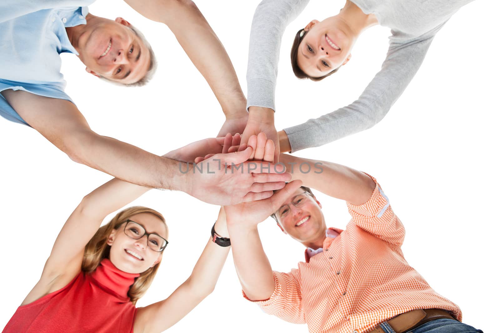 Conceptual teamwork and cooperation image of four casual middle-aged friends isolated on white