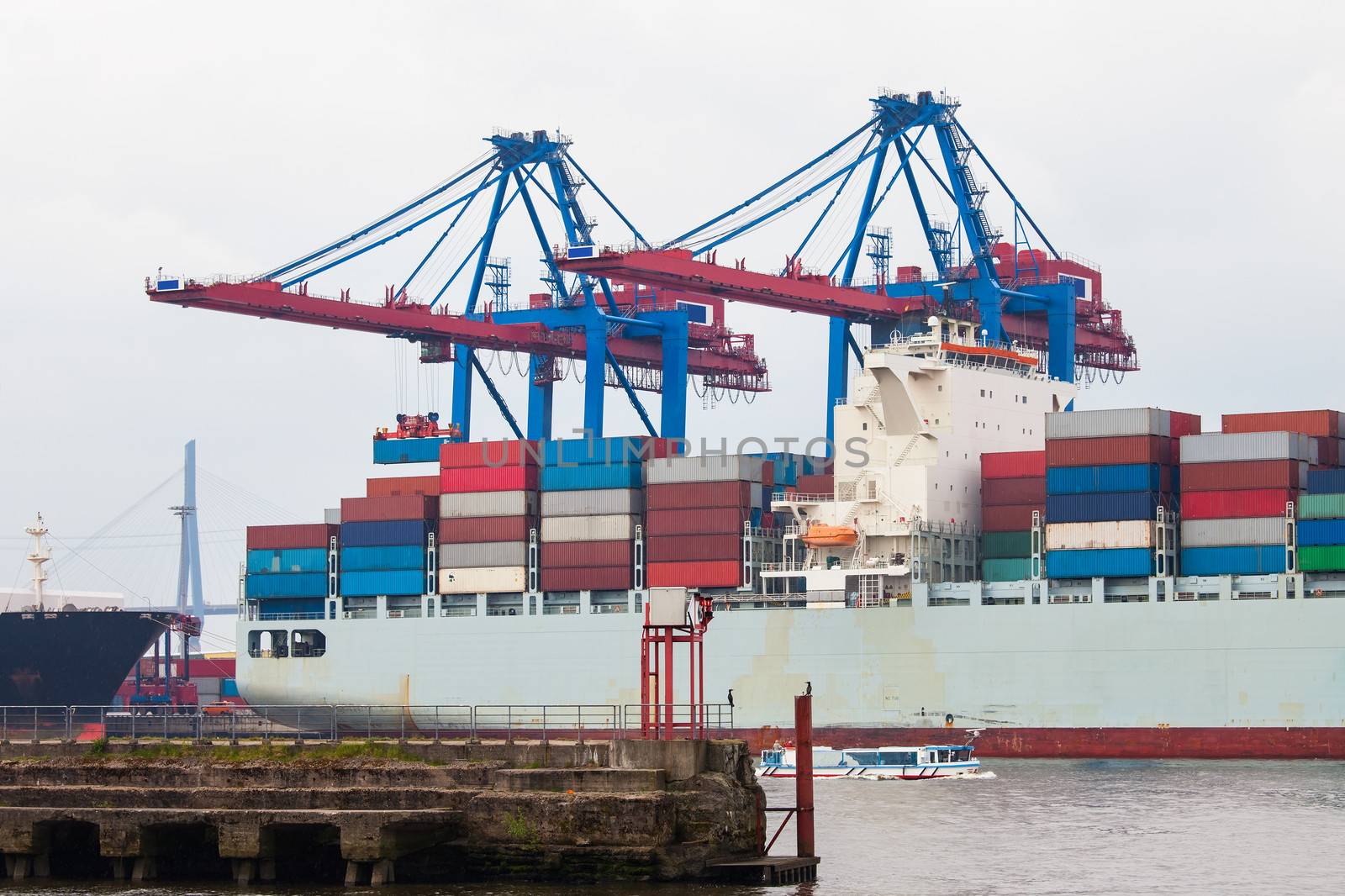 Container ship in port terminal by AndreyPopov