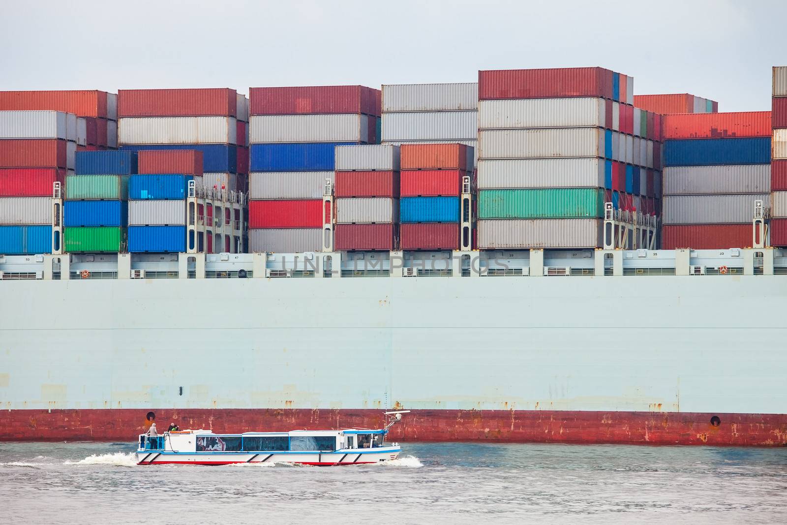 Huge container ship fully loaded in port terminal