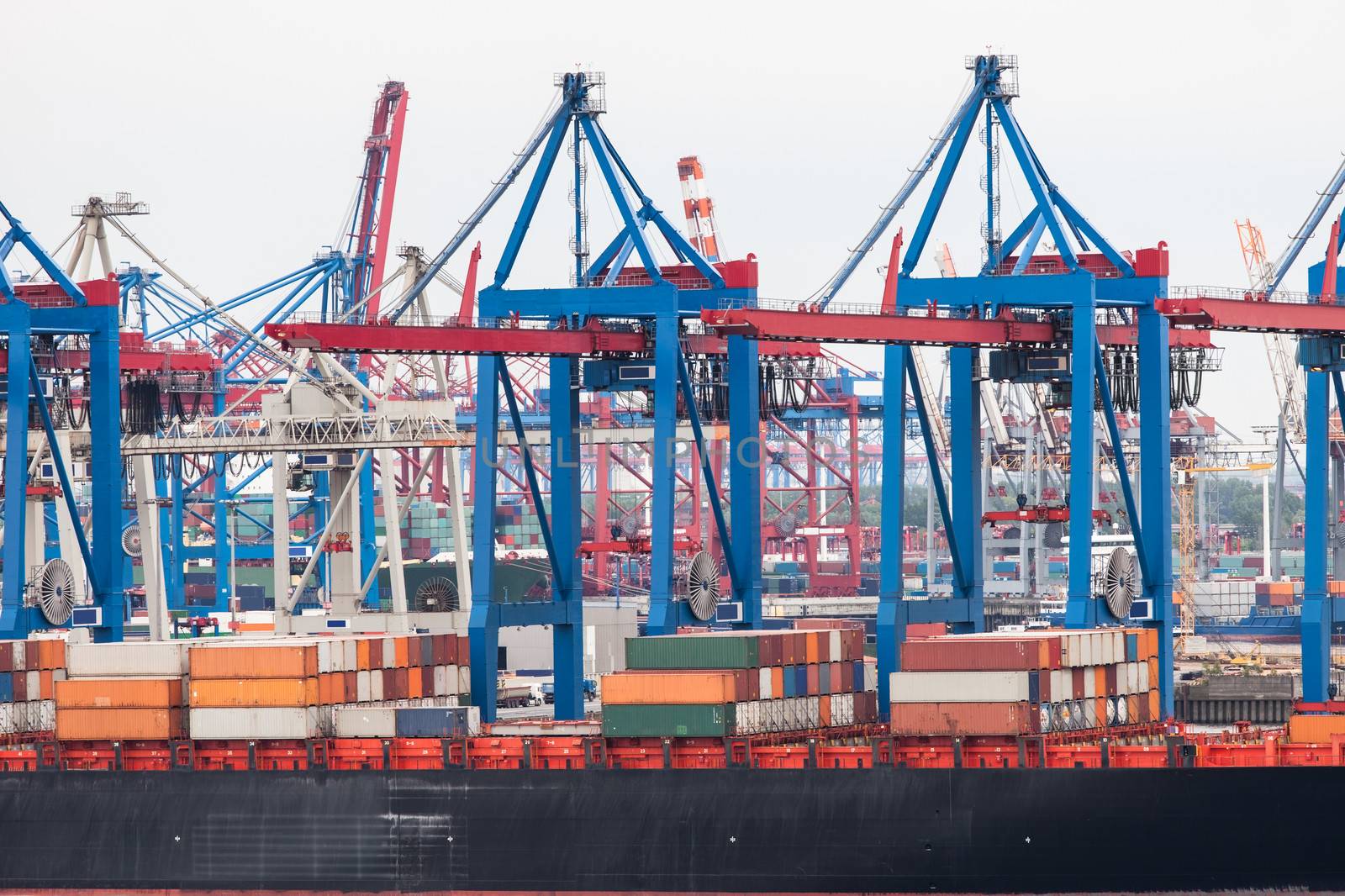 Container ship in port terminal by AndreyPopov