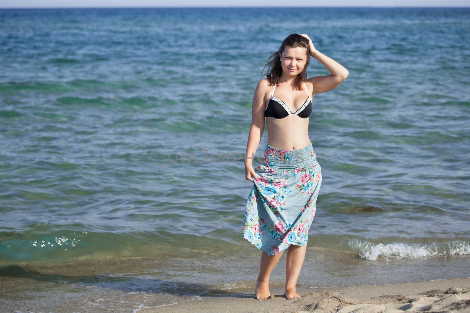 Beautiful young woman at the beach at Mediterranean Sea