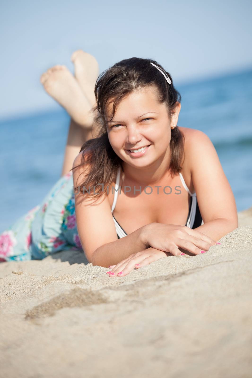Beautiful young woman relaxing at the beach by AndreyPopov