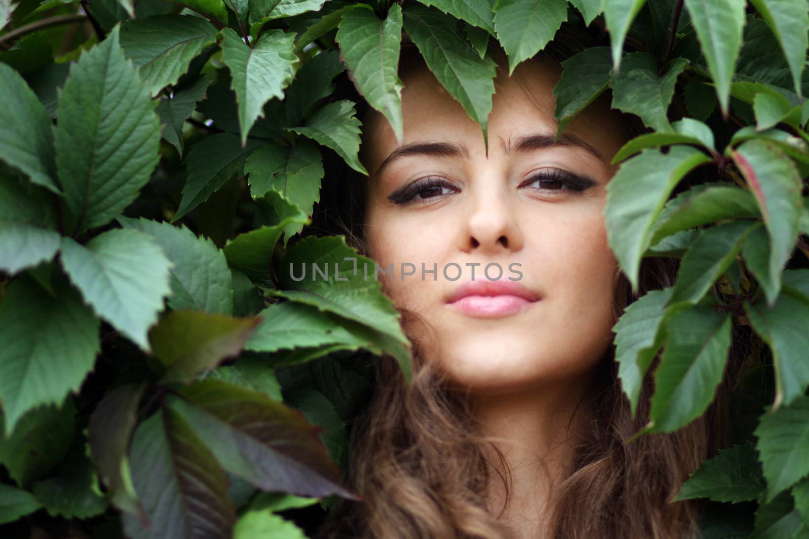 Portrait of the girl in green foliage