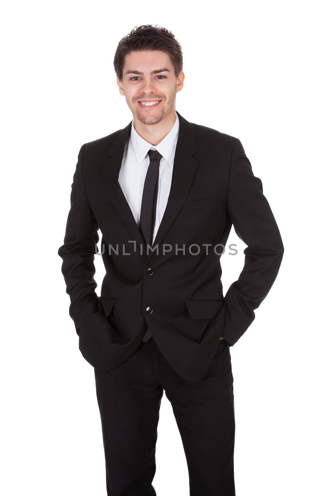 Businessman standing with folded arms by AndreyPopov