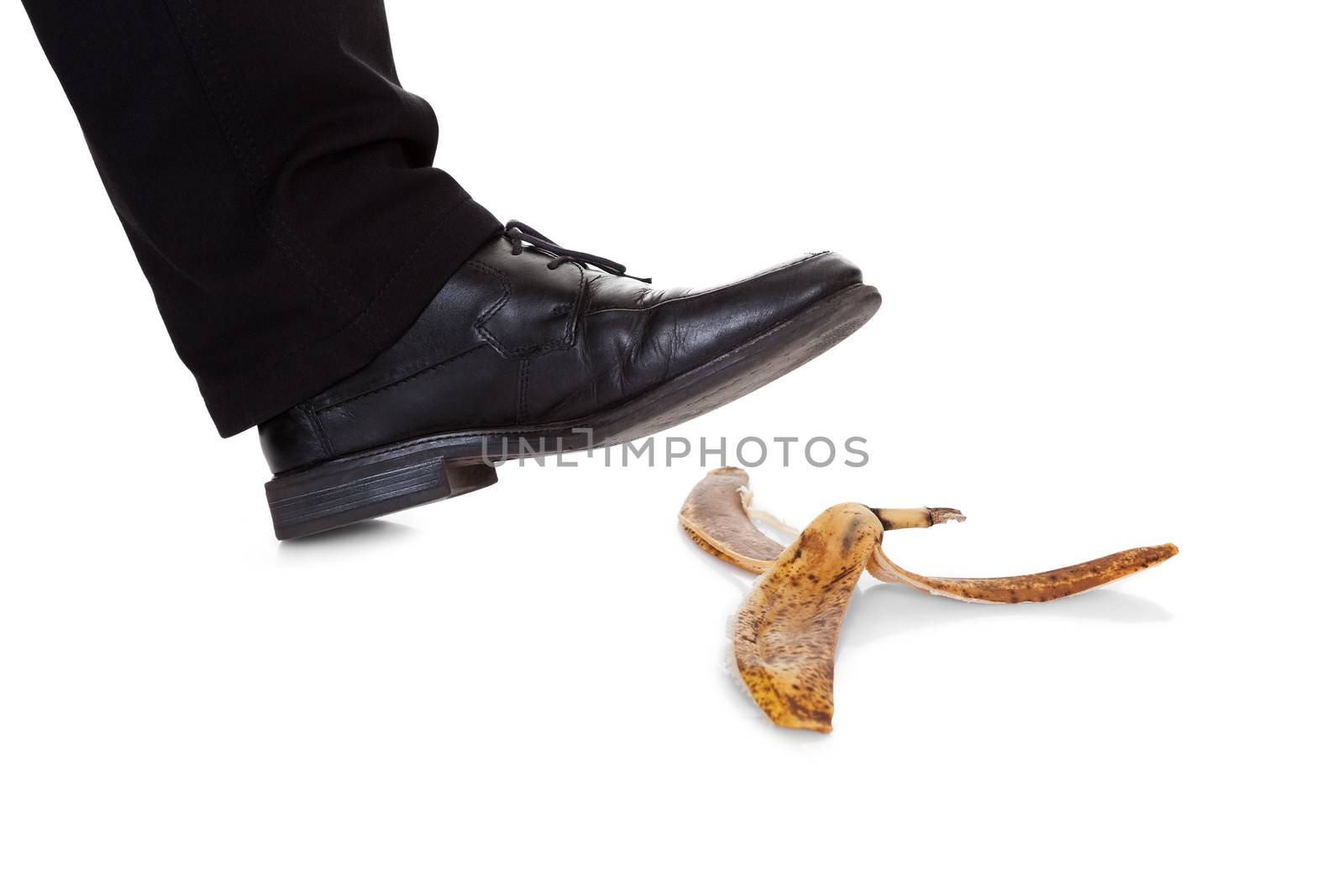 Businessman slipping on banana peel by AndreyPopov