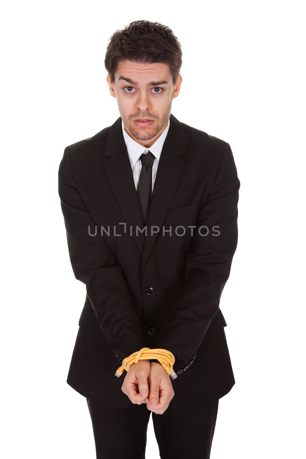 Businessman with hands tied in network cable. Isolated on white