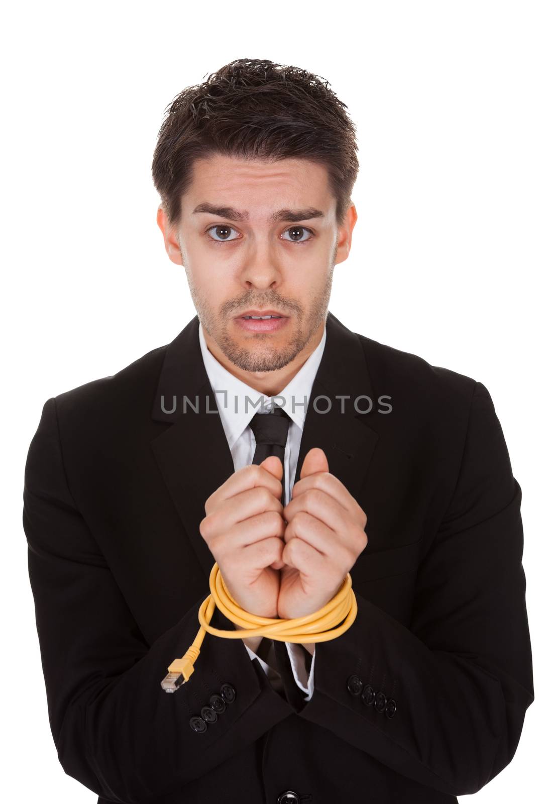 Businessman with hands tied in network cable. Isolated on white