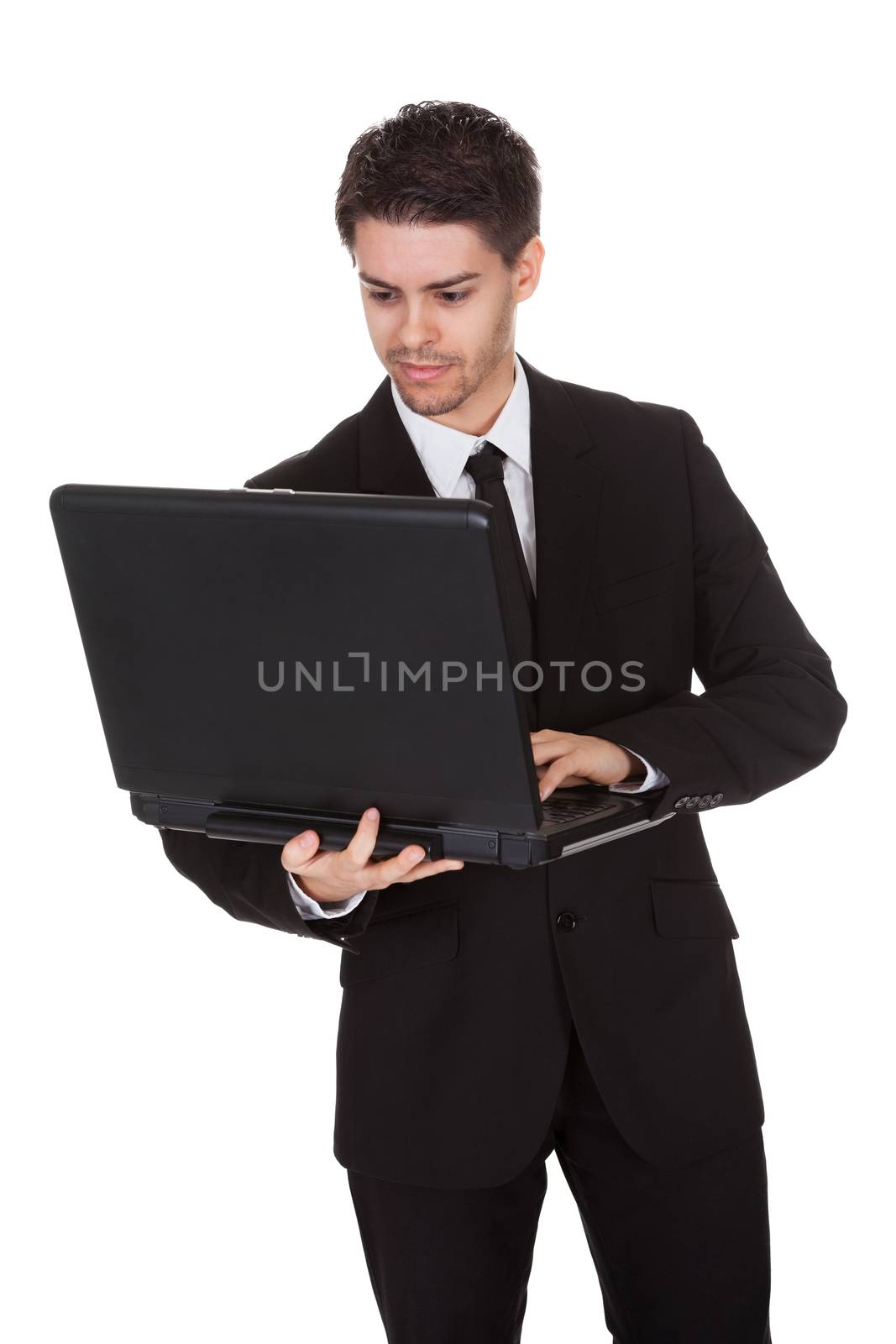 Businessman working on laptop. Isolated on white