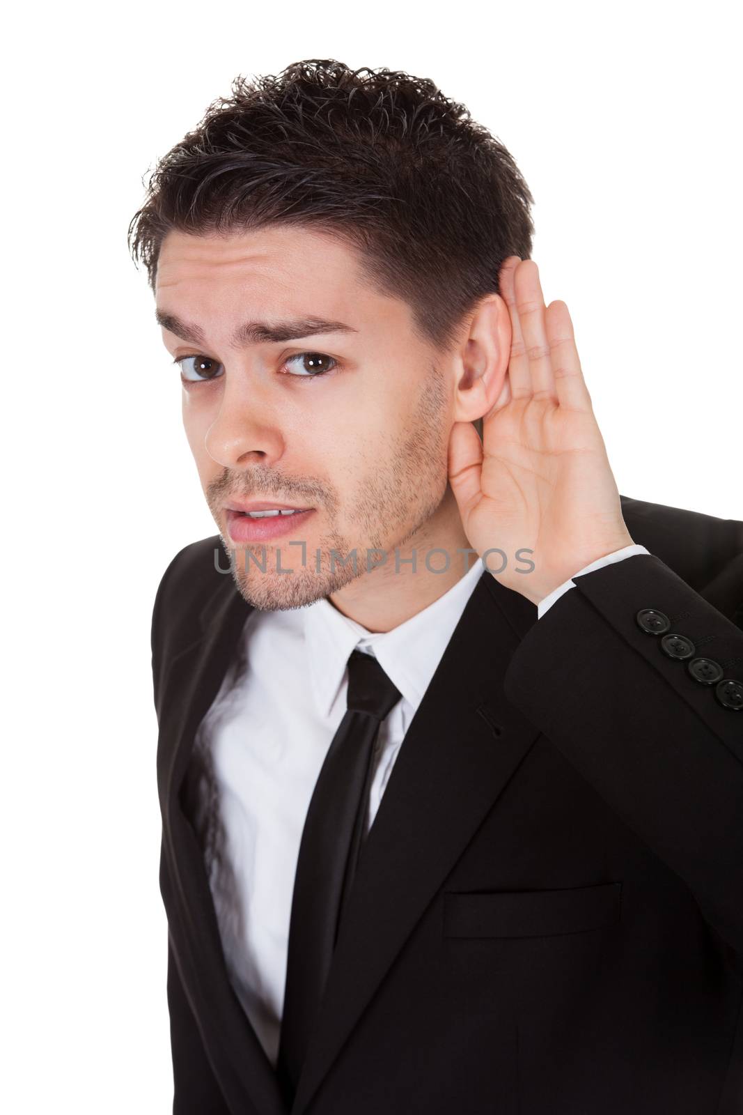 Businessman holding his hand to his ear isolated on white