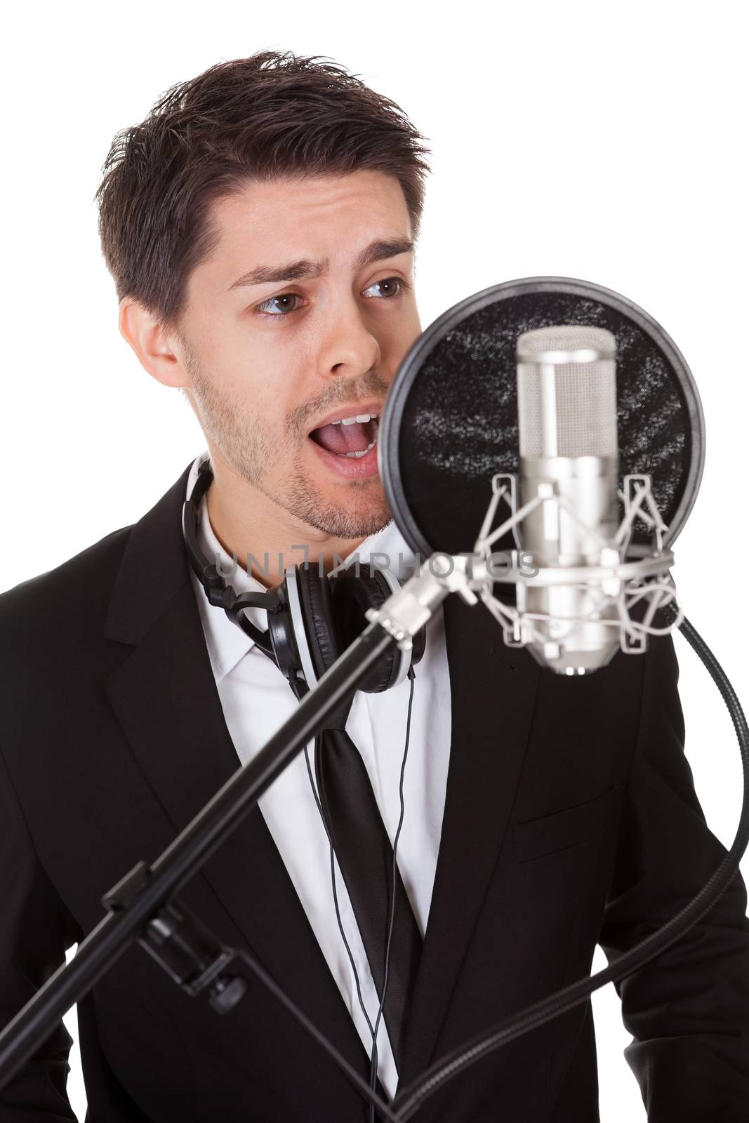 Young singer and microphone. Isolated on white