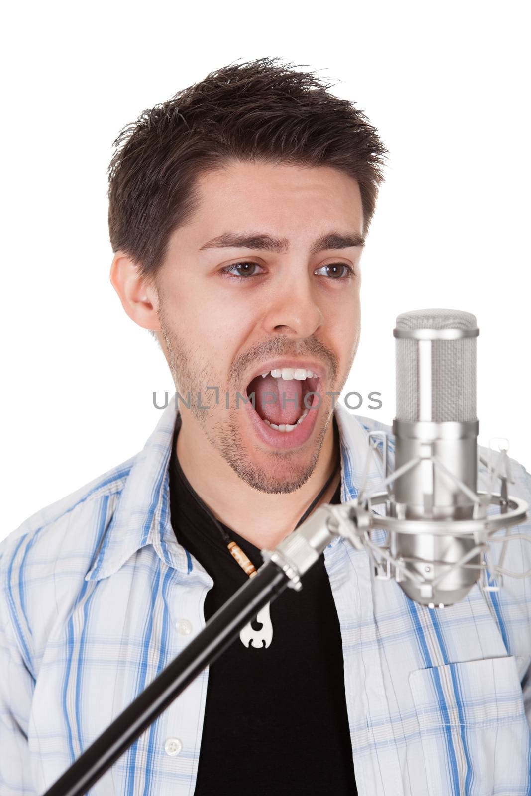 Young singer and microphone. Isolated on white