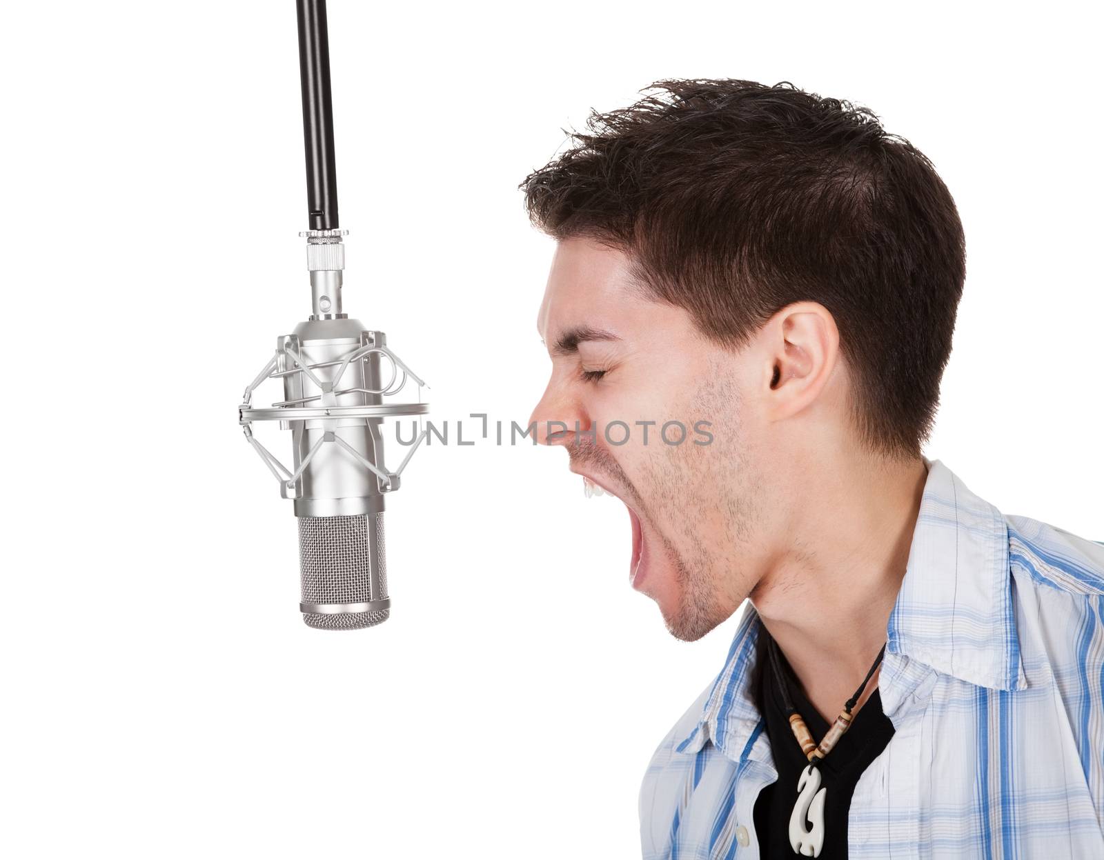 Portrait of a young singer screaming into microphone