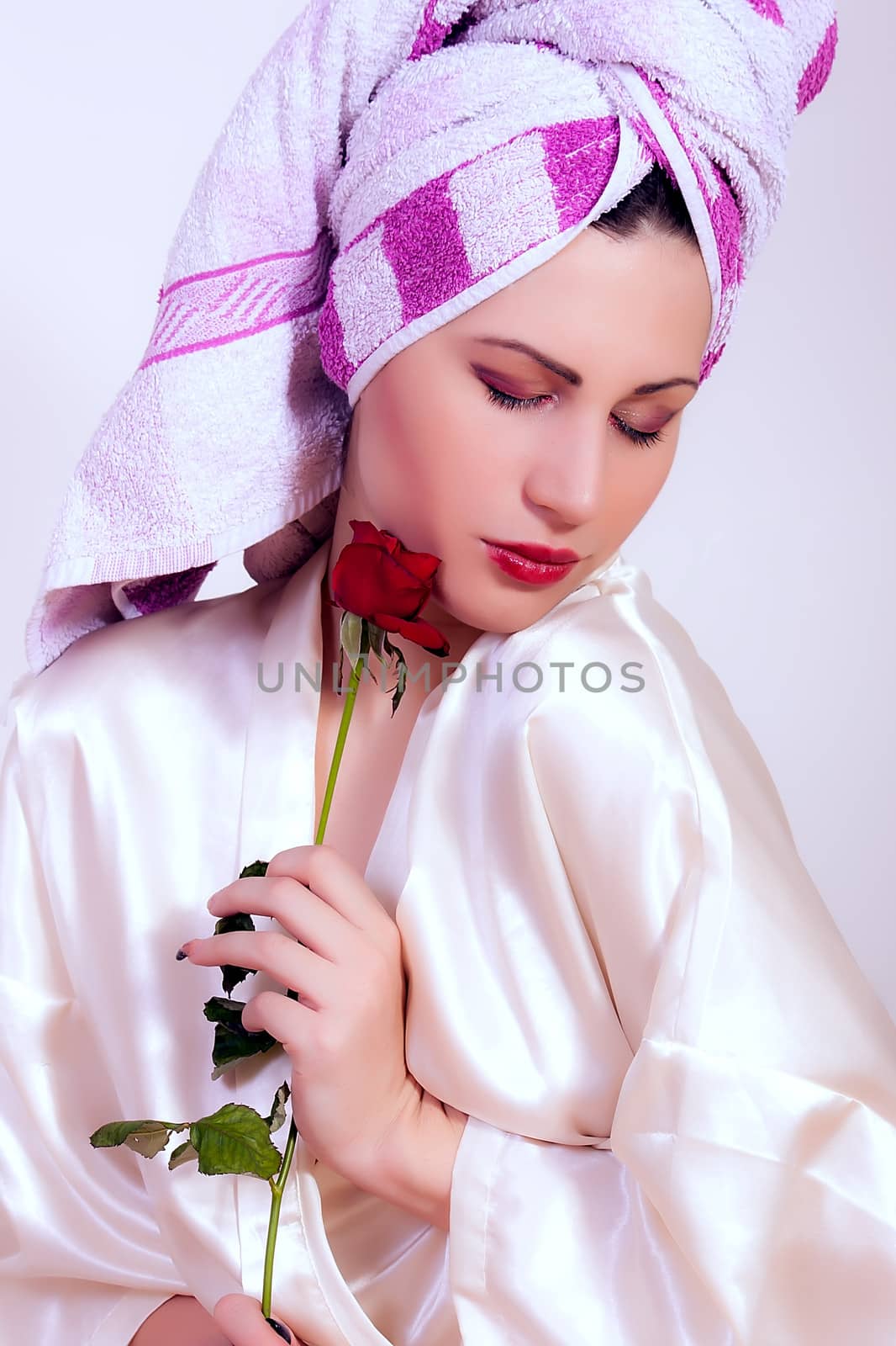 Beautiful young woman holding a flower by dukibu