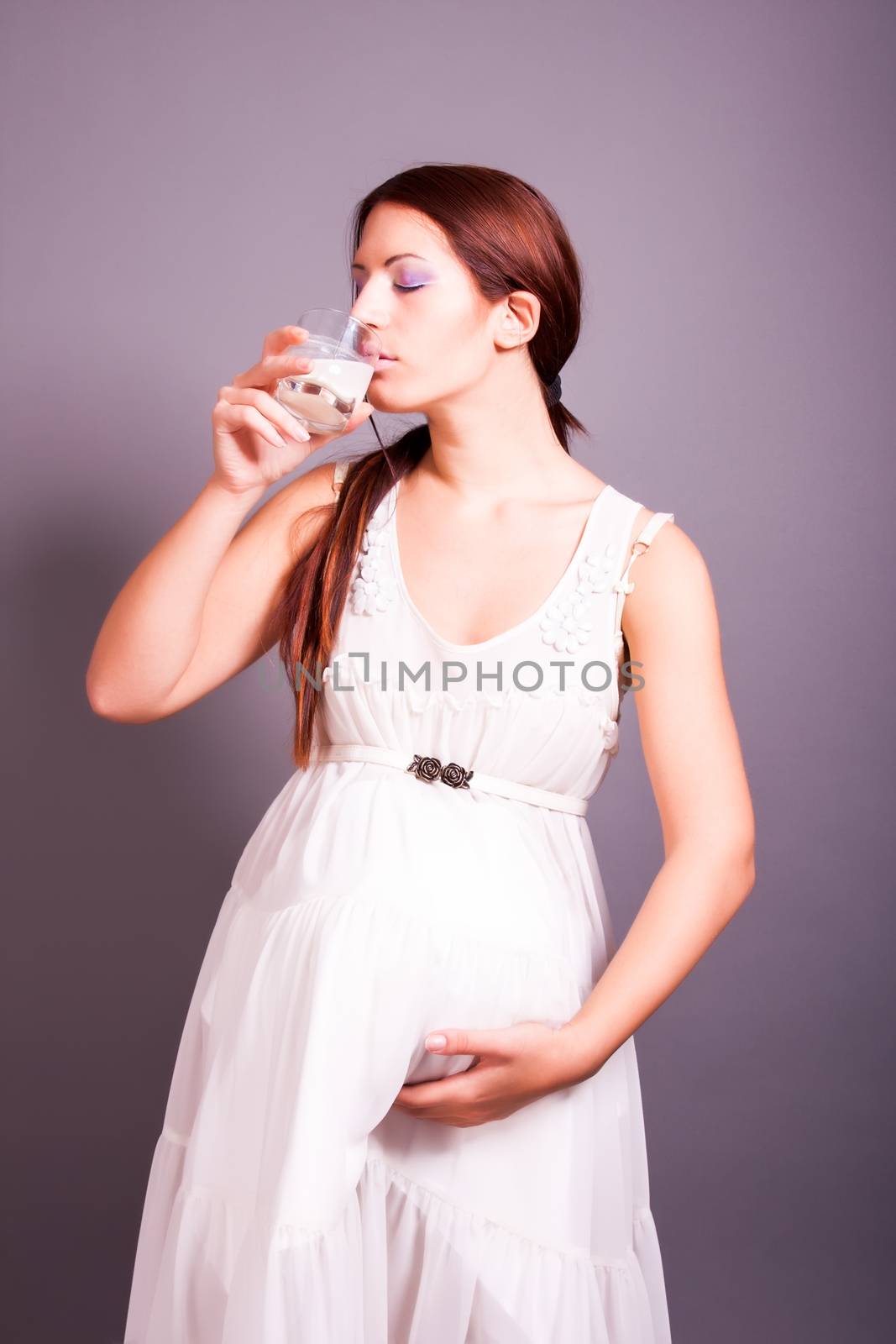 portrait of pregnant woman drinking milk