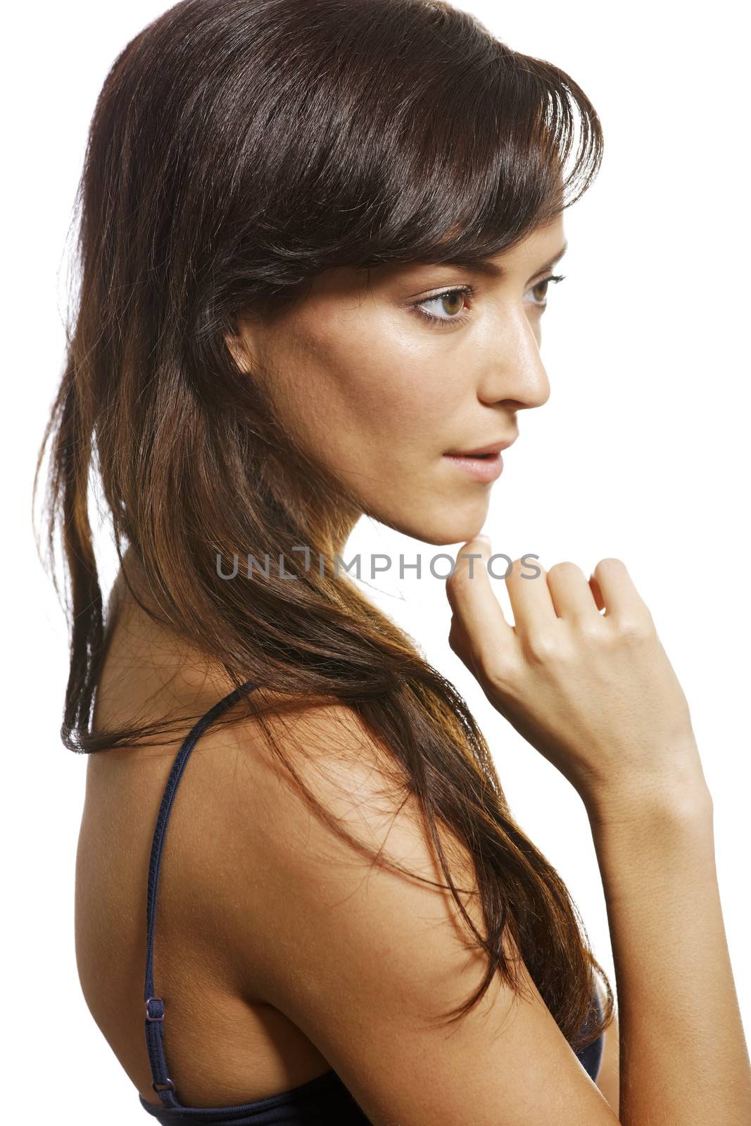 Beautiful young woman with a stern expression on white background