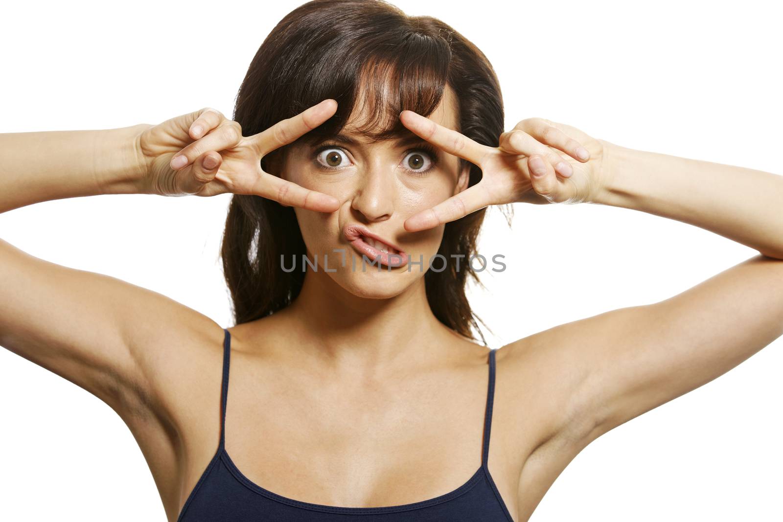 Woman covering her eyes with her hands in a victory expression
