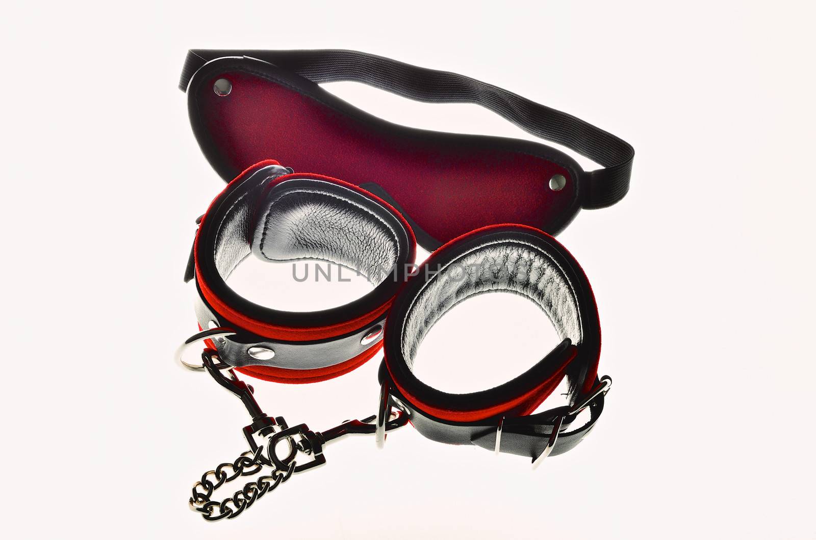 Red leather handcuffs and bandage for eyes