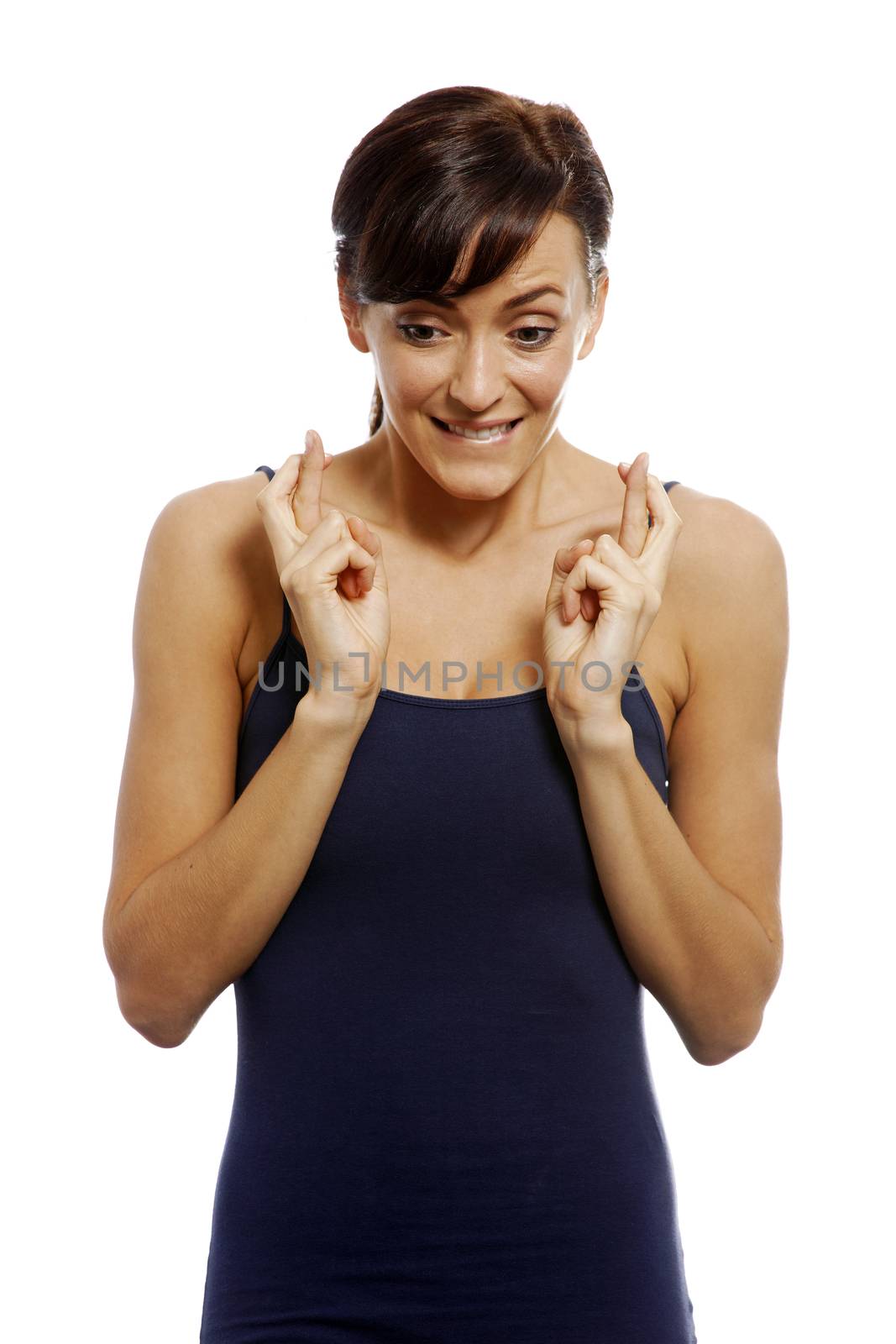 Young woman with crossed fingers looking hopeful