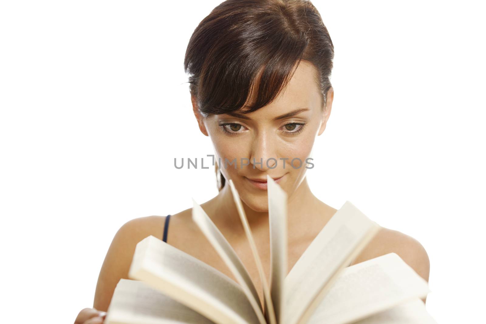 Young woman flicking through the pages of a book