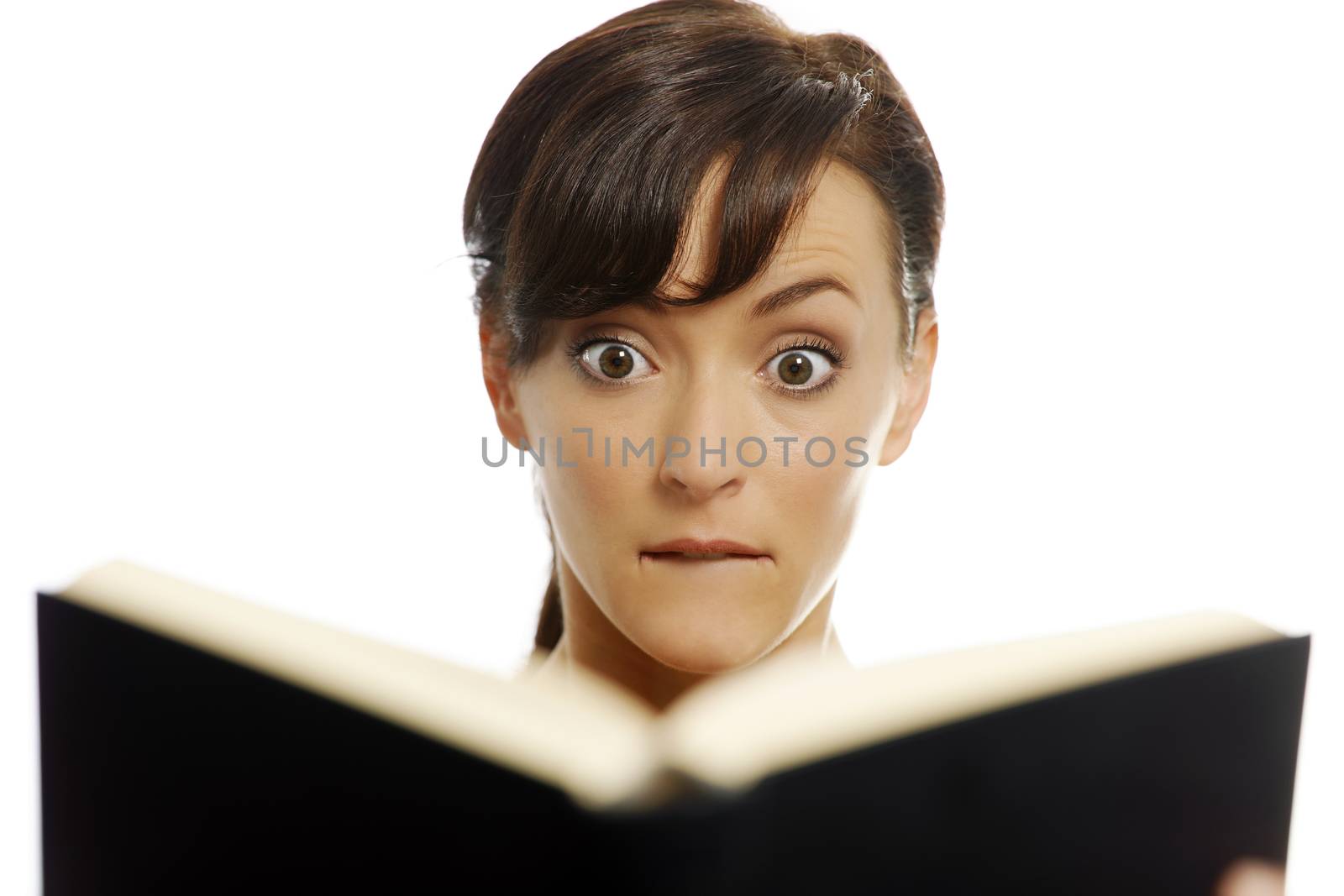 Young woman reading a scary book