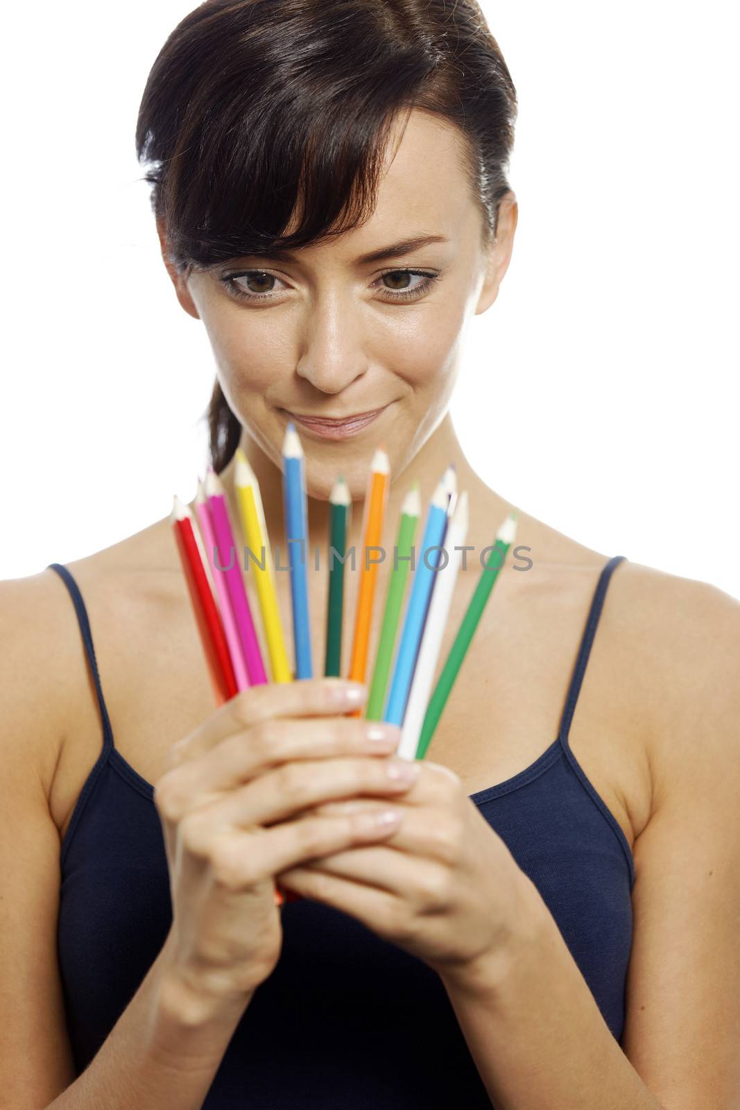 Young woman holding an assortment of colouring pencils