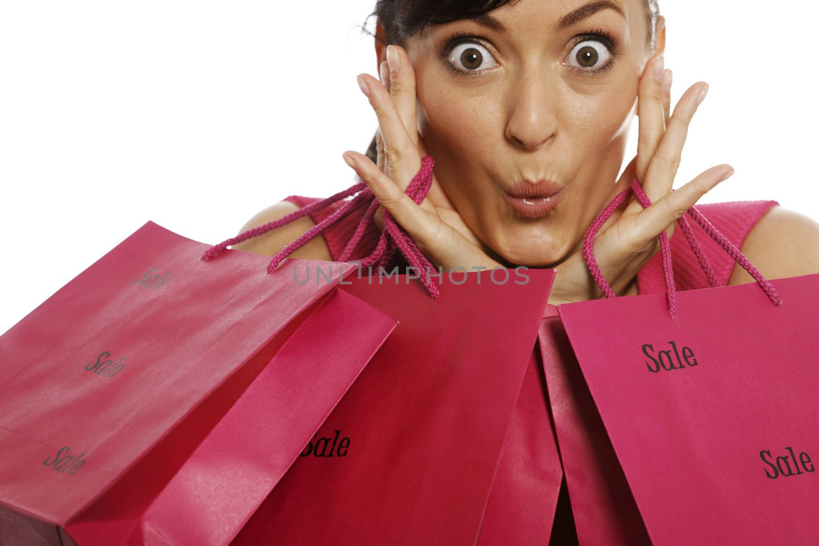 Young woman looking excited with shopping bags