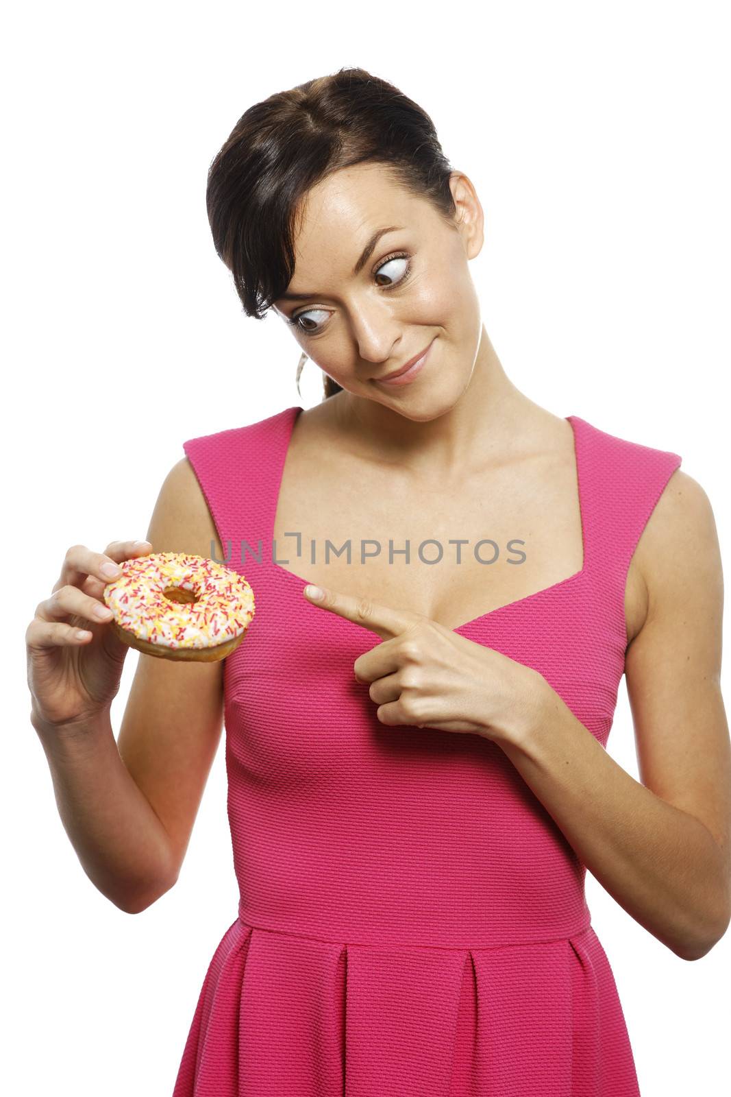 Young woman holding a doughnut looking guilty