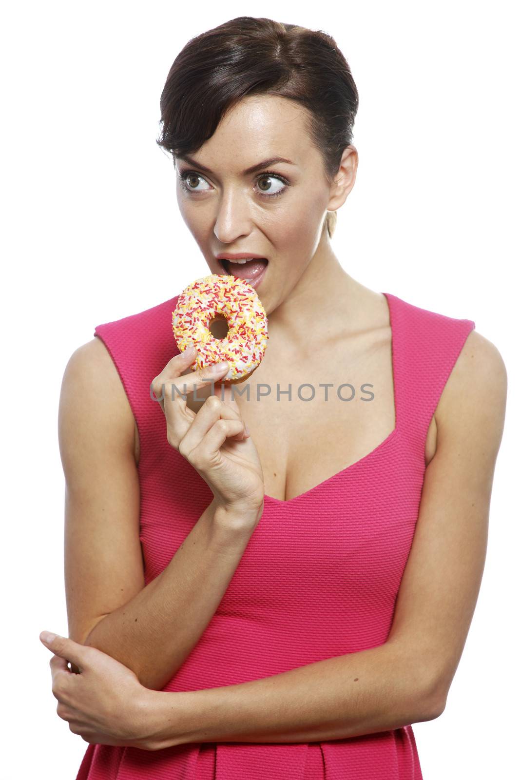 Young woman holding a doughnut looking guilty