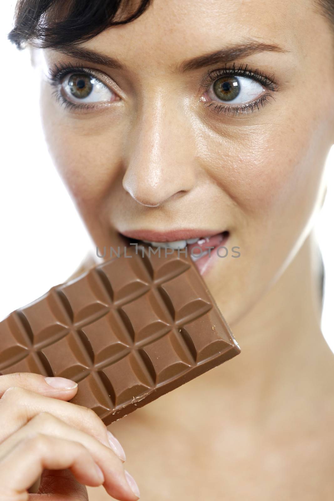 Young woman eating a huge chocolate bar