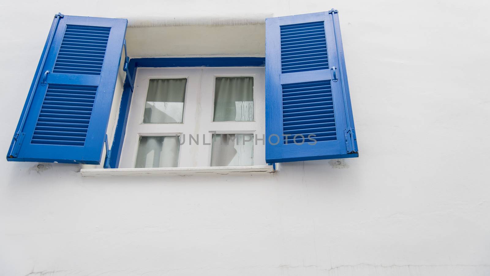 Open blue window on white wall1 by gjeerawut