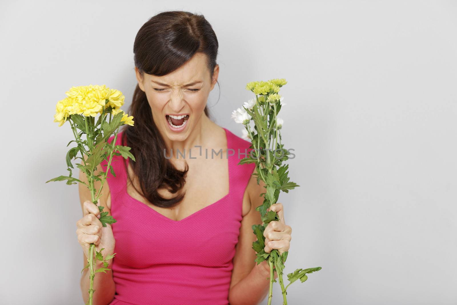Young woman expressing anger with her flowers.