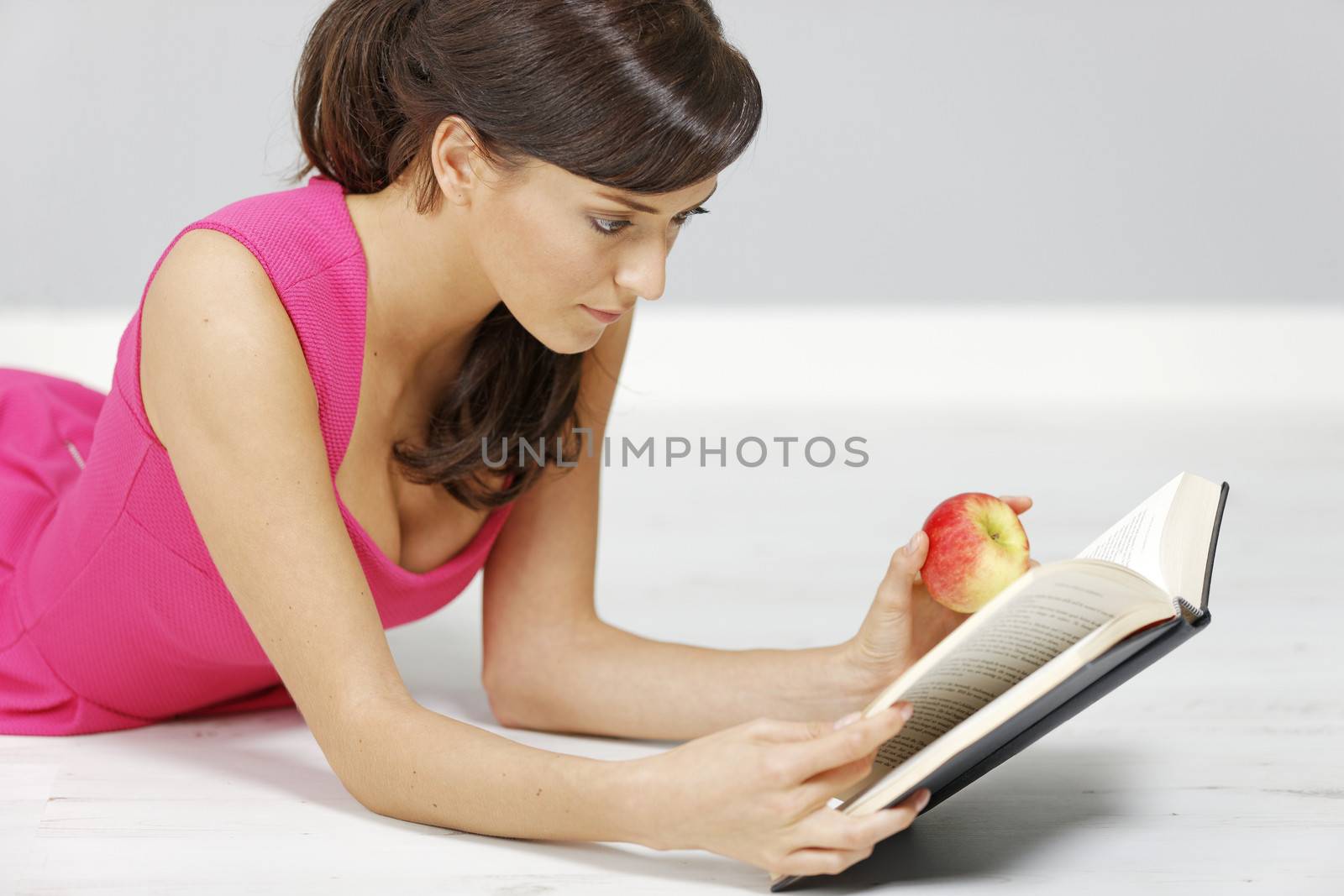 Woman reading at home by studiofi
