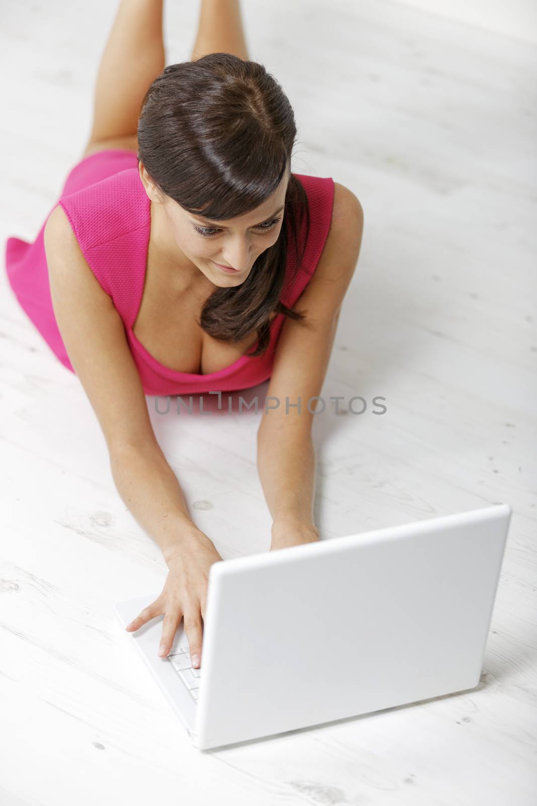Woman using laptop by studiofi