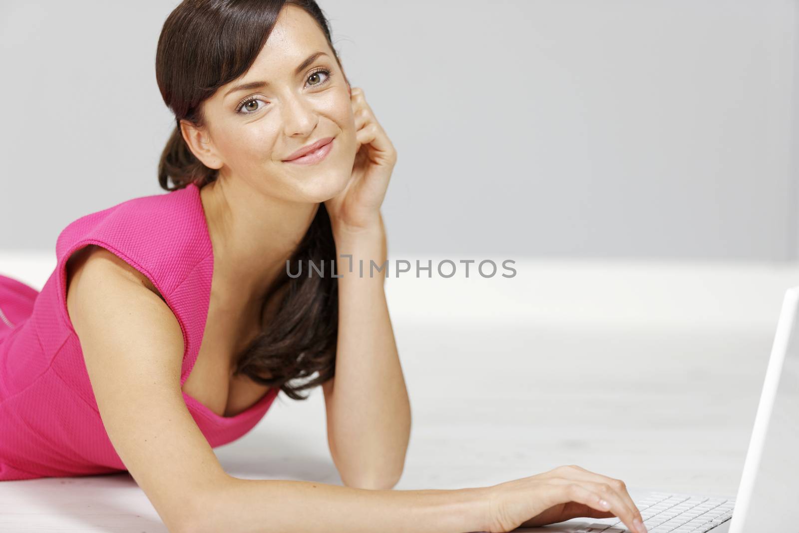 Young woman using a laptop computer at home.