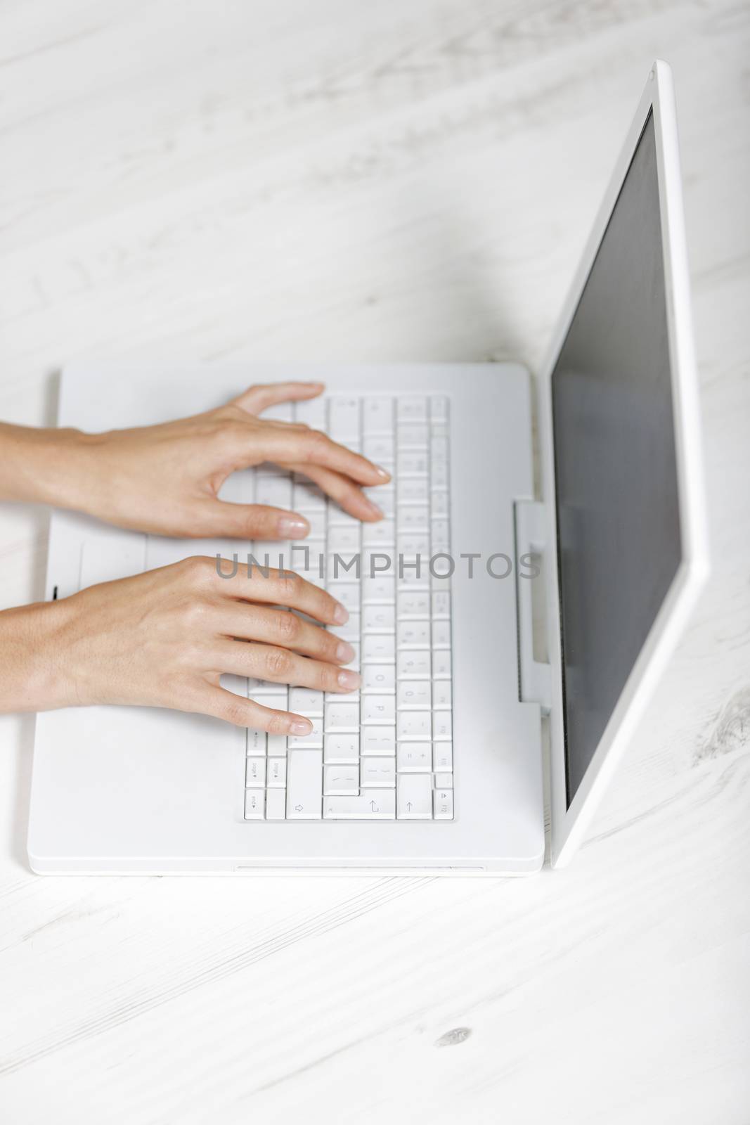 Modern computer keyboard with female hands typing