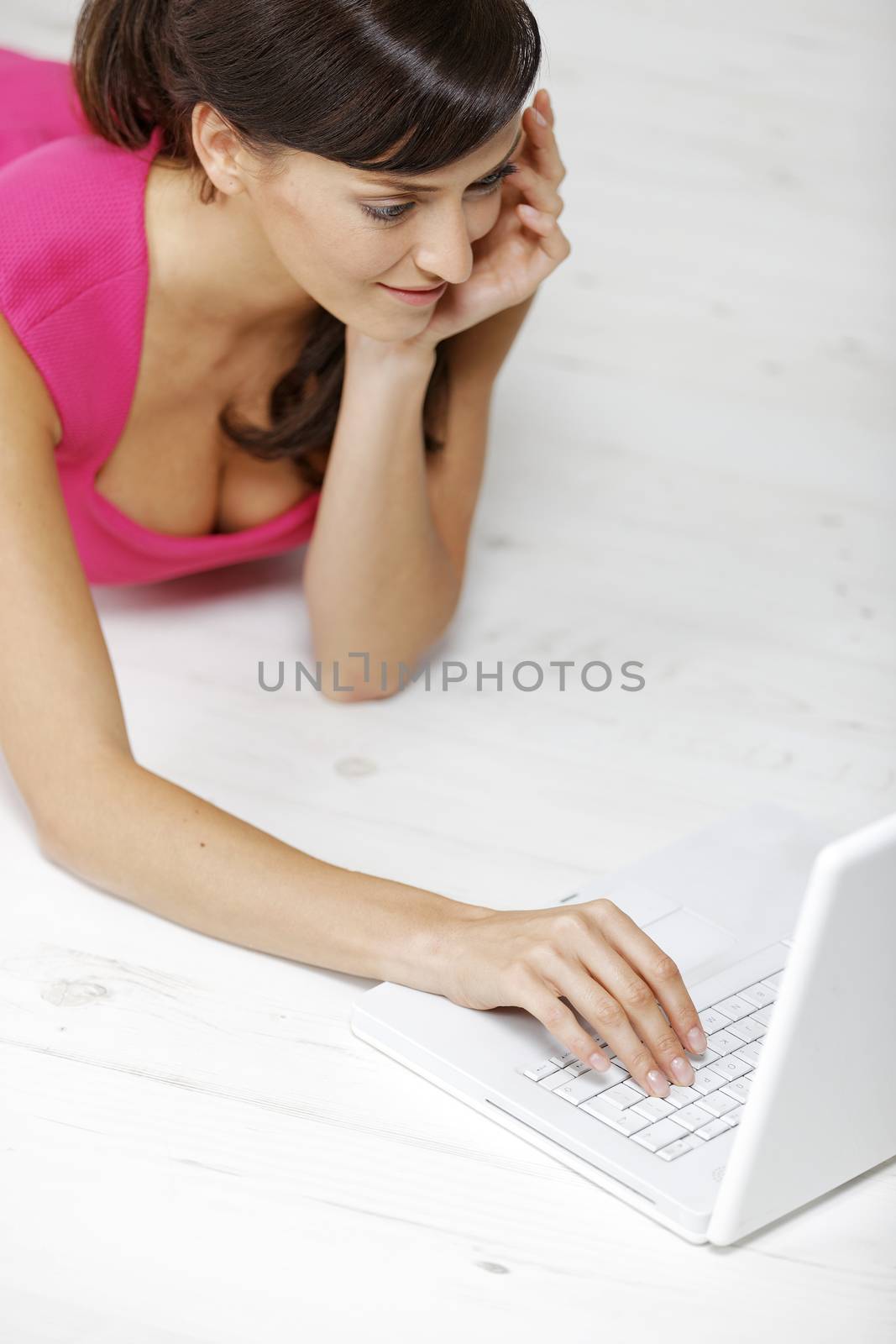 Young woman using a laptop computer at home.