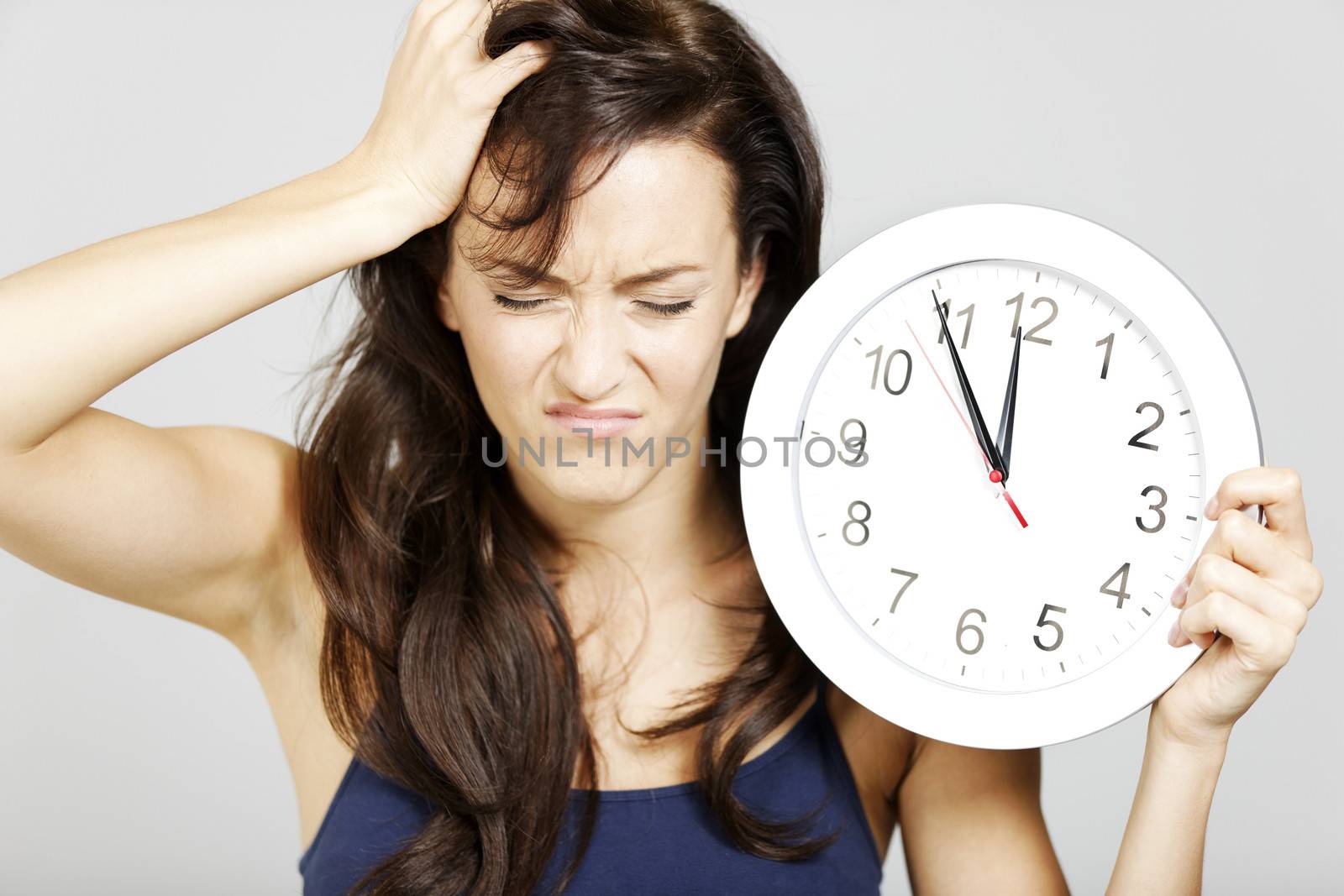 Woman with clock face looking concerned.