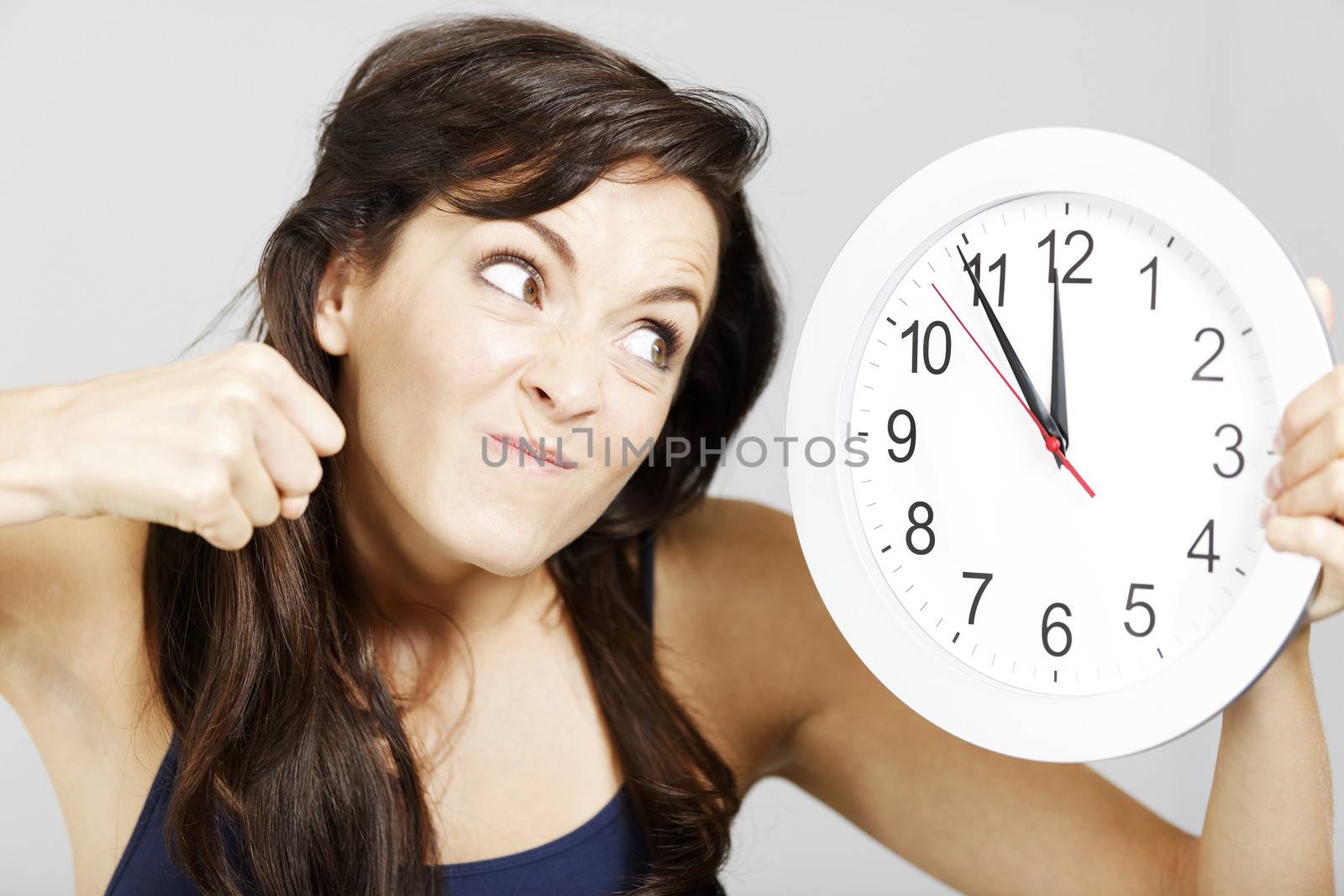 Woman with clock face looking concerned.