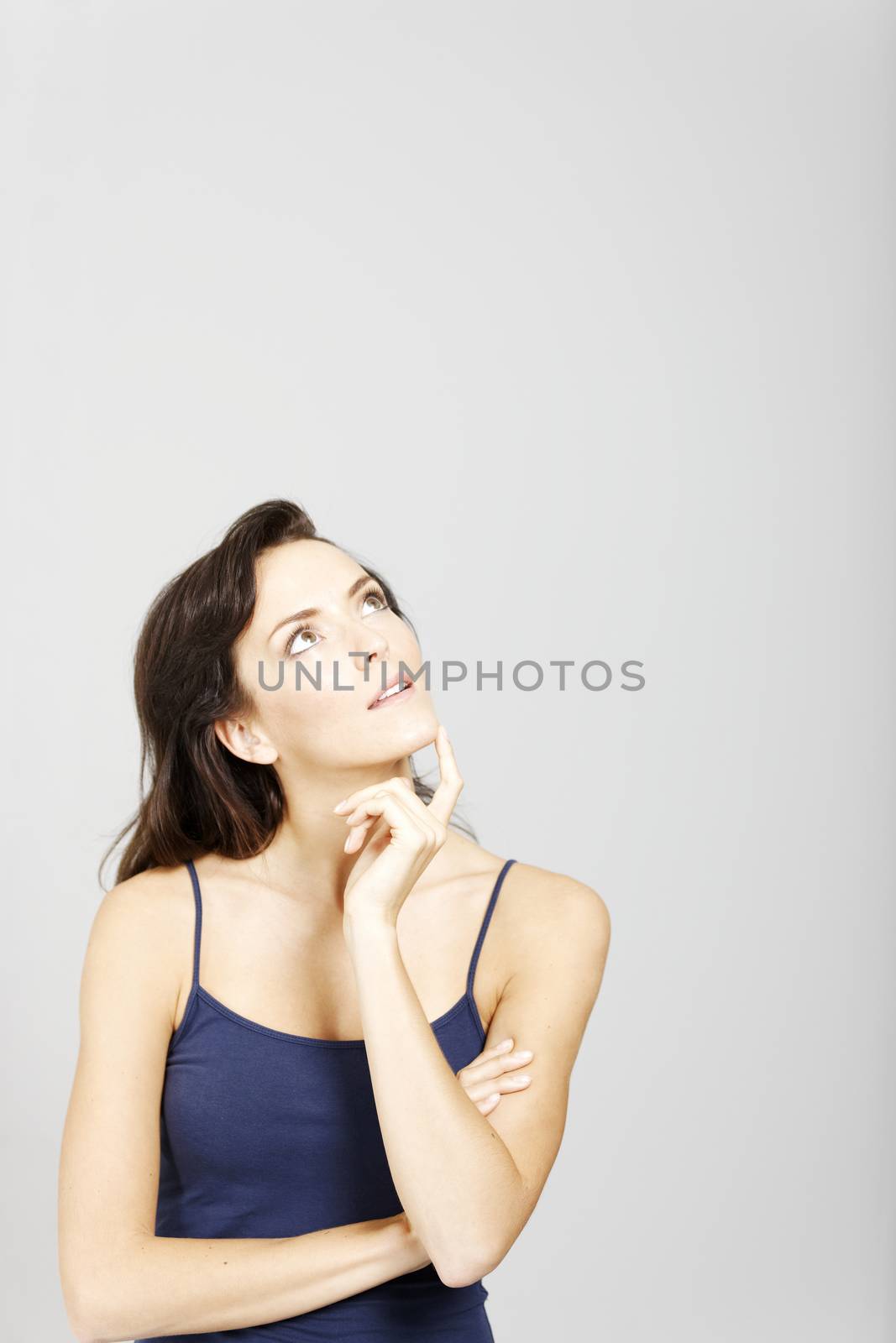 Young woman looking to her left expressing an idea or thought.