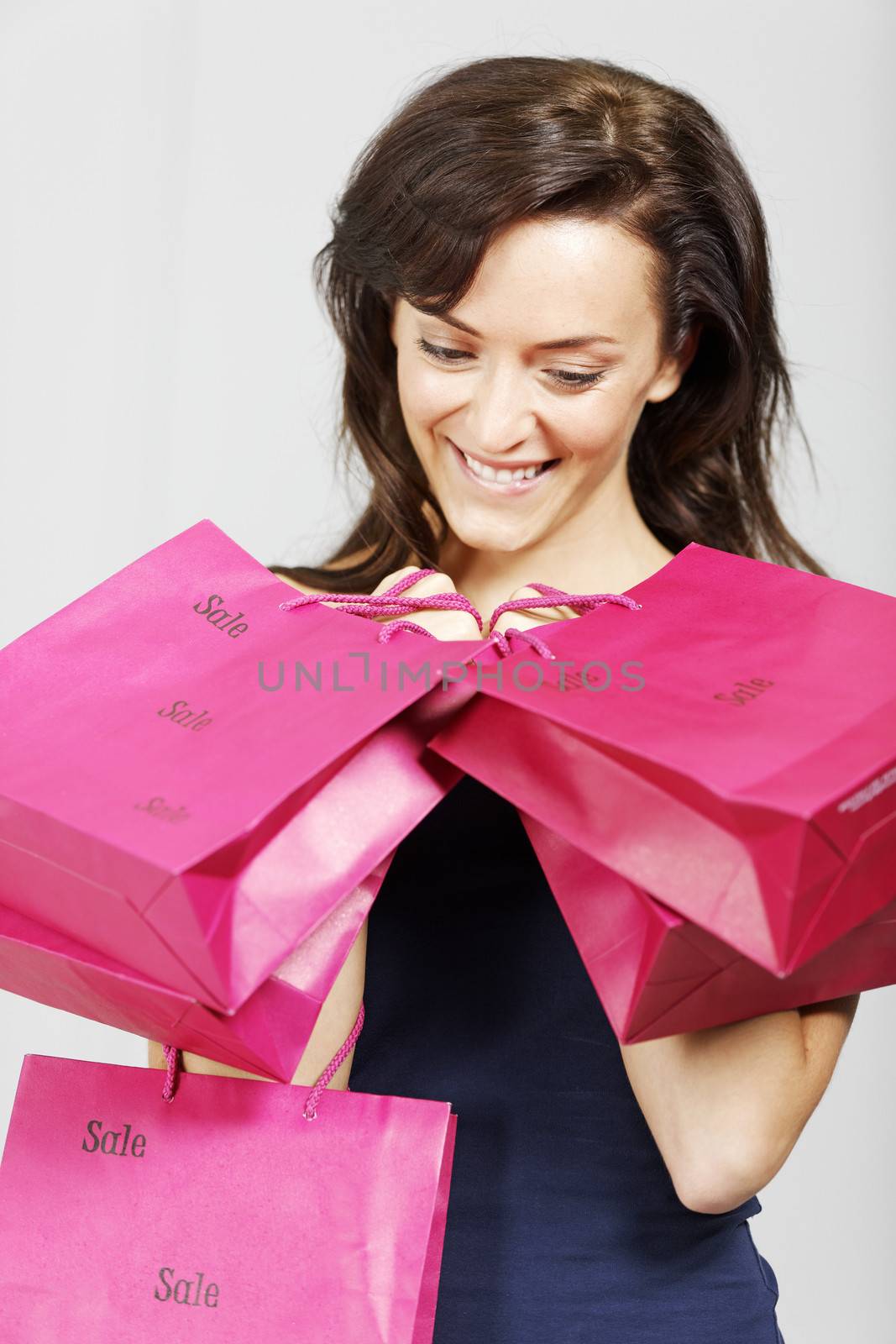 Young woman looking excited with shopping bags from the sales