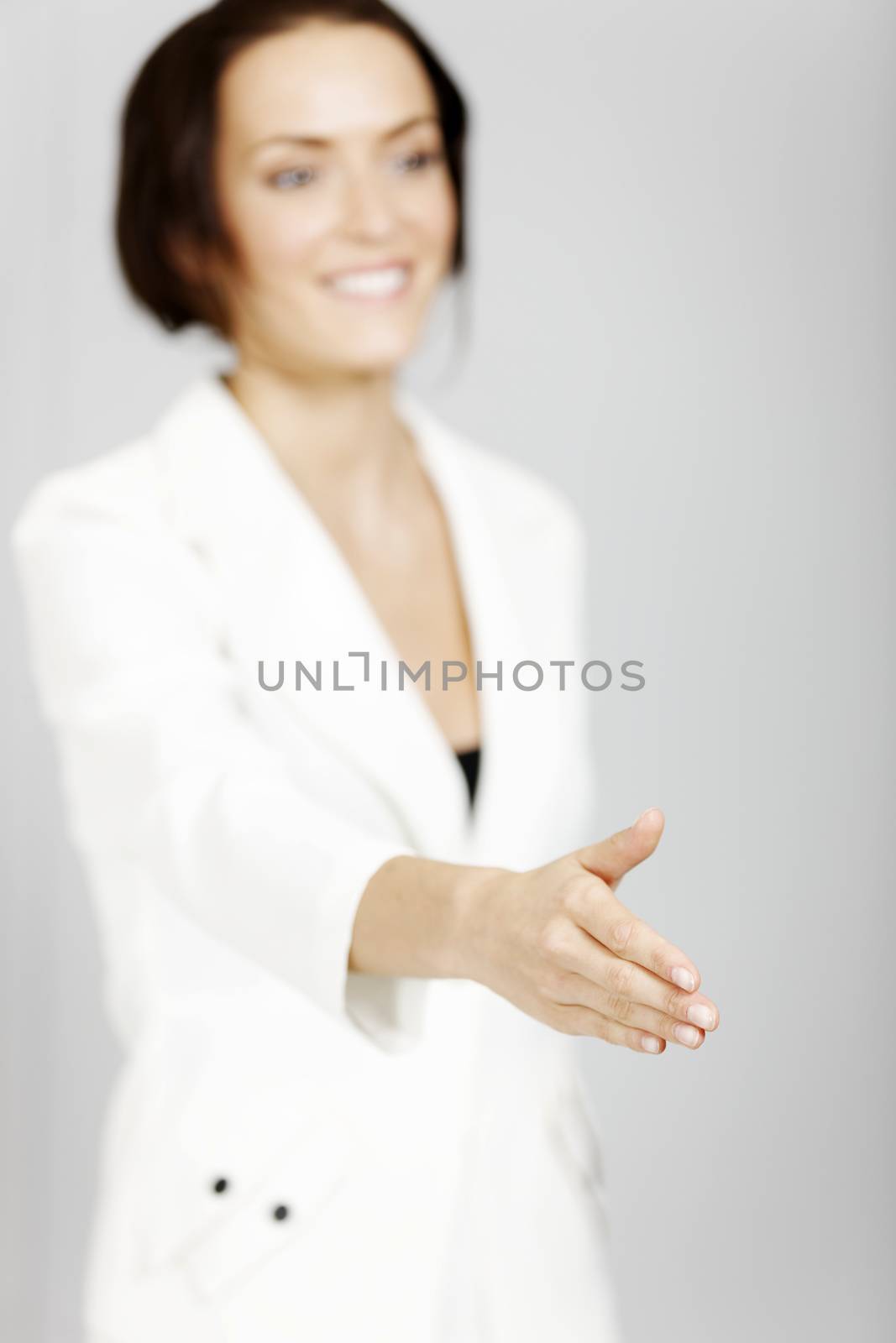 Young business woman extending her hand in greeting