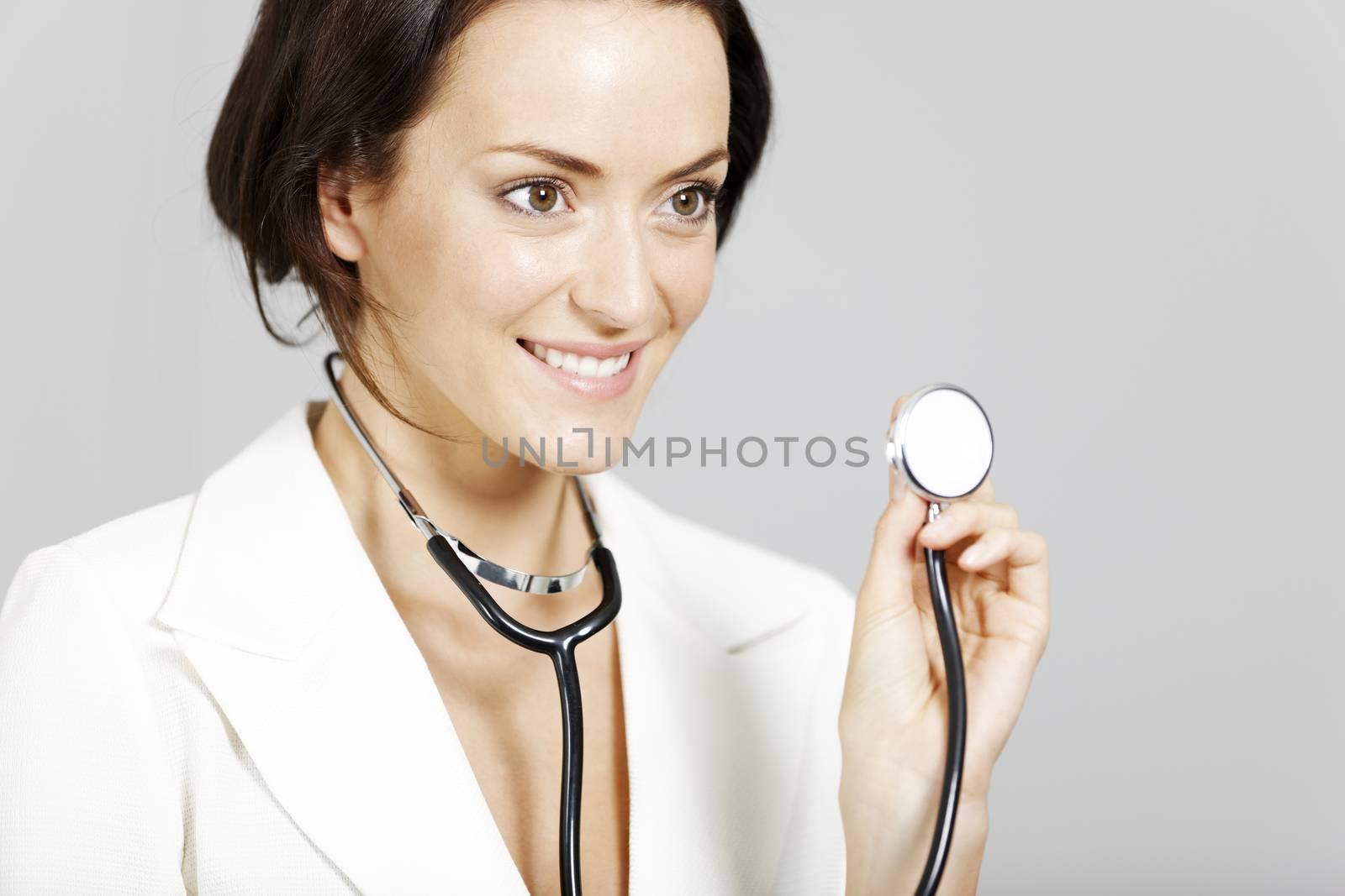 Helpful young doctor with stethoscope.