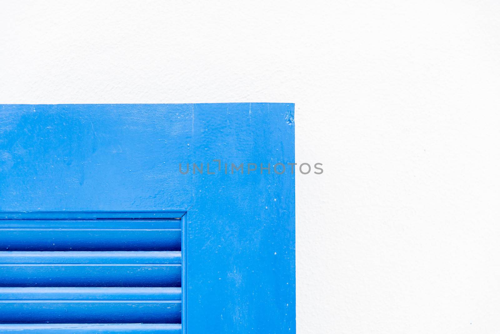 Edge of blue wooden window with white wall2