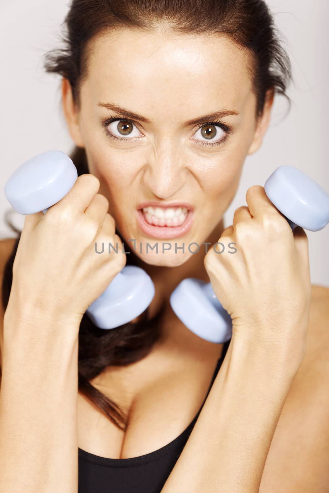 Woman training with dumbbells