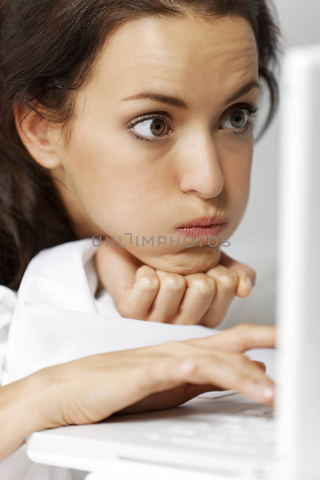 Young woman using her laptop in bed