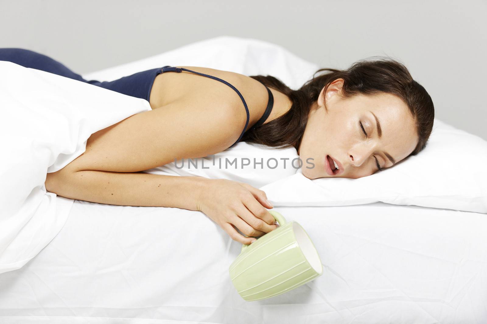Woman asleep in bed by studiofi