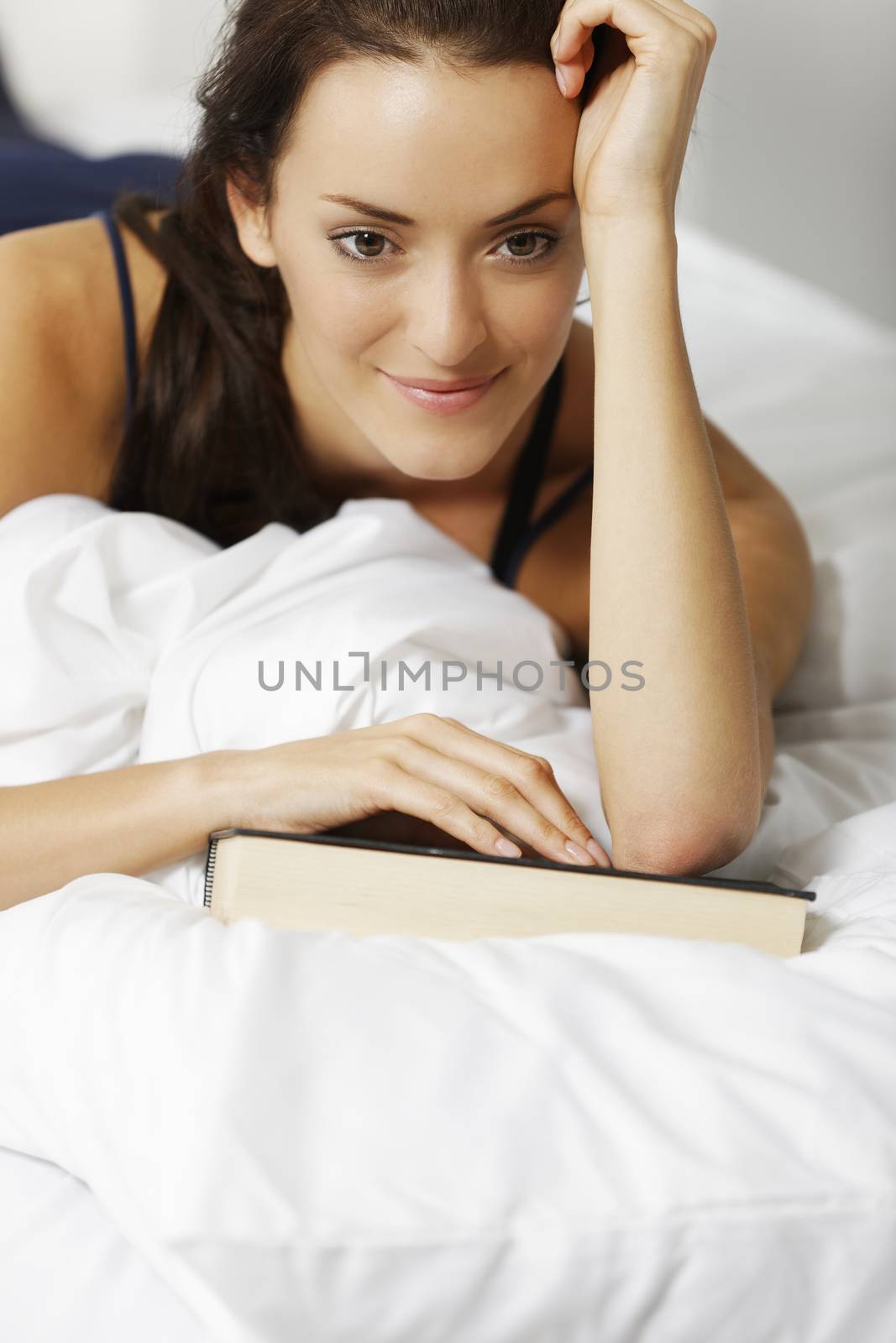 Woman reading book by studiofi