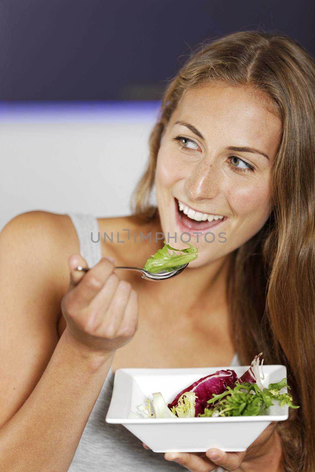 Young woman enjoying a fresh salad.
