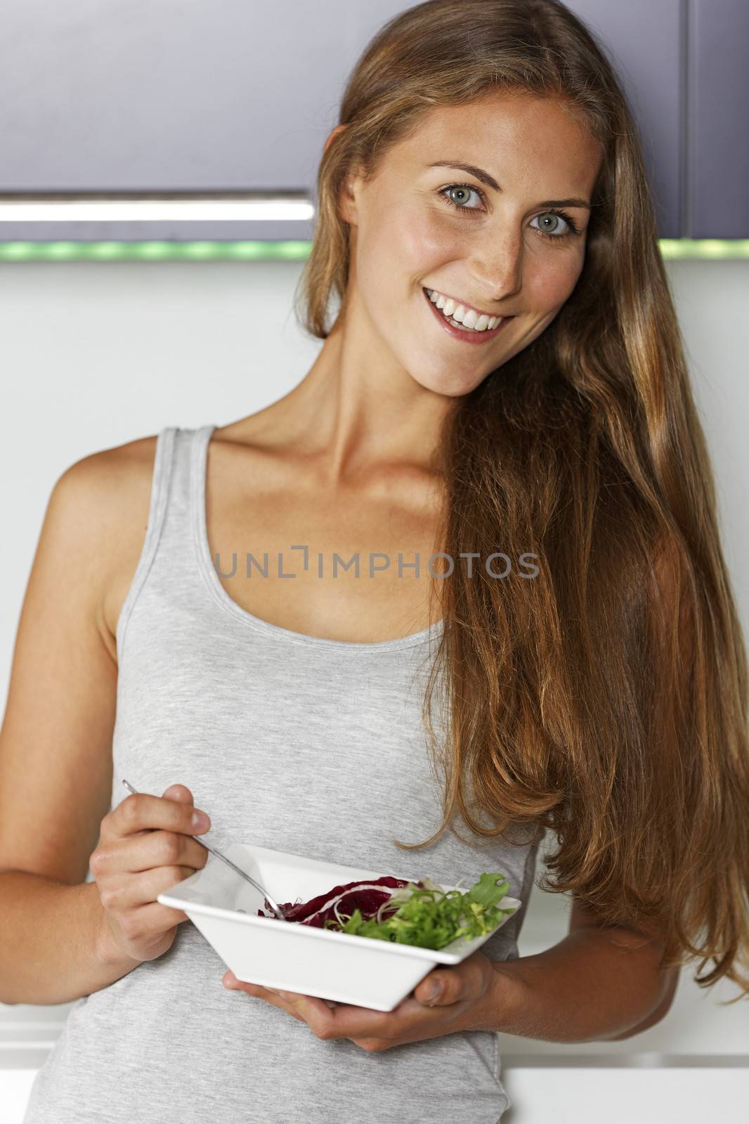 Young woman enjoying a fresh salad.