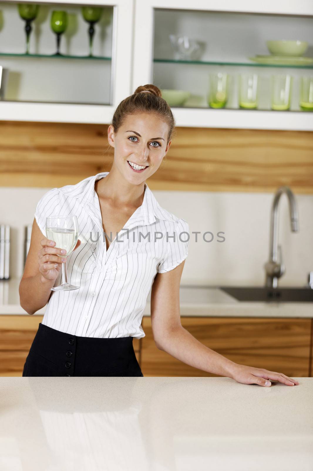 Young business woman relaxing at home with a glass of wine.